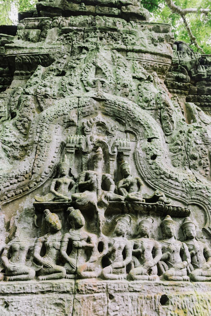 Detailed stone carving of ancient temple figures, evoking rich history and art.