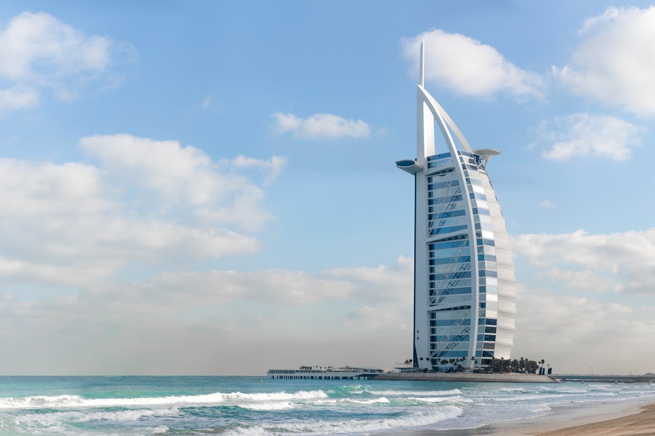 our-story-01 Stunning view of Burj Al Arab with a serene beach setting in Dubai, UAE.