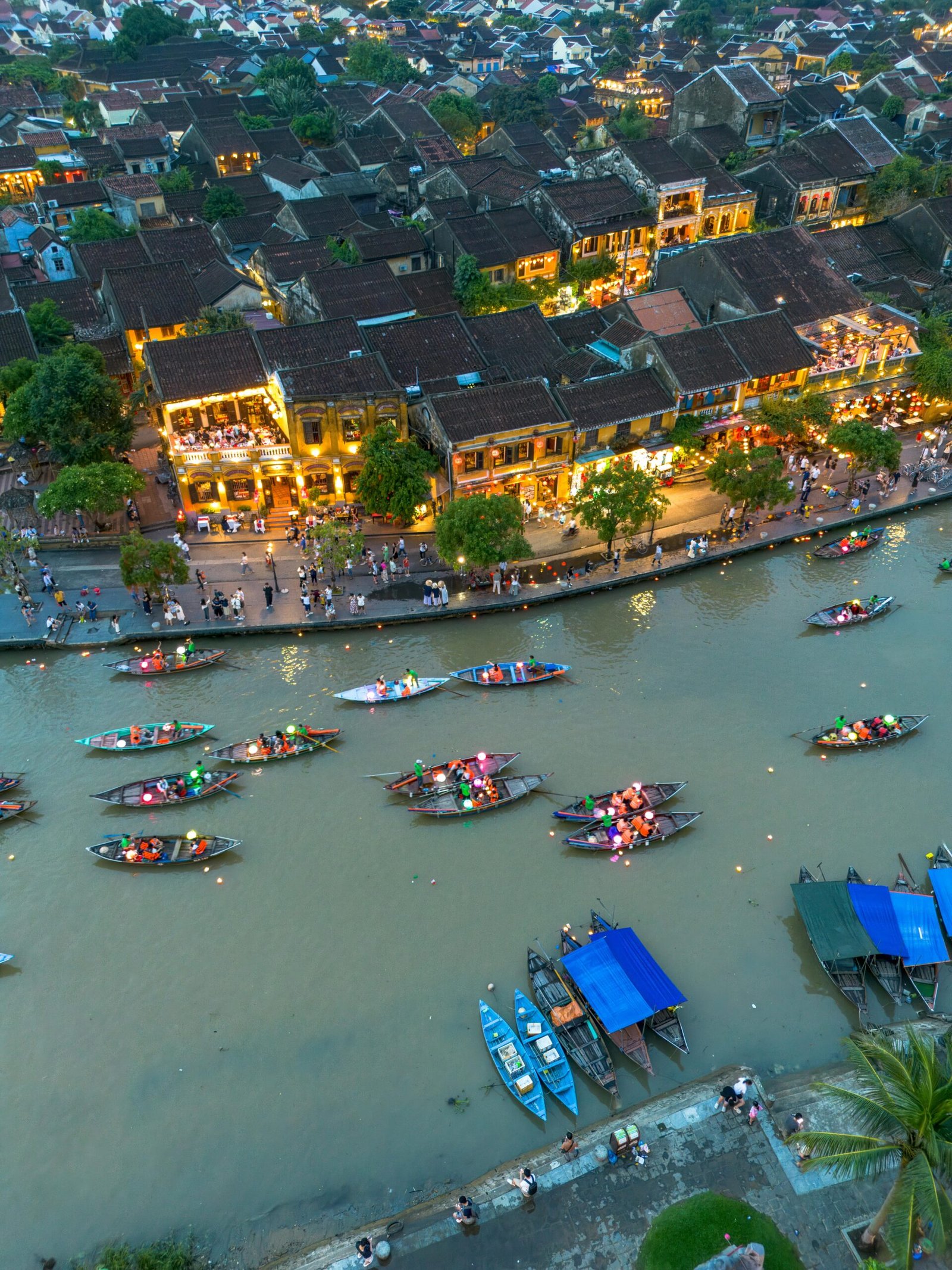 Vibrant aerial view of Hội An's lantern-lit boat festival at night, showcasing the town's unique charm.
