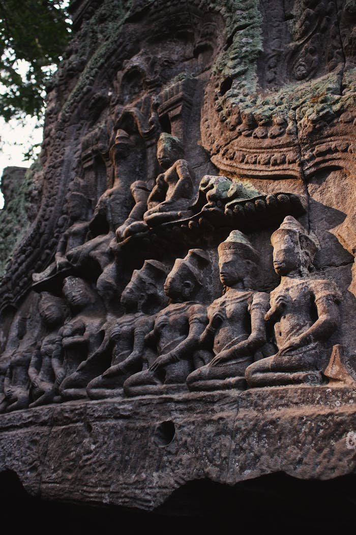 Close-up of detailed stone carvings on a Cambodian temple, showcasing religious artistry.